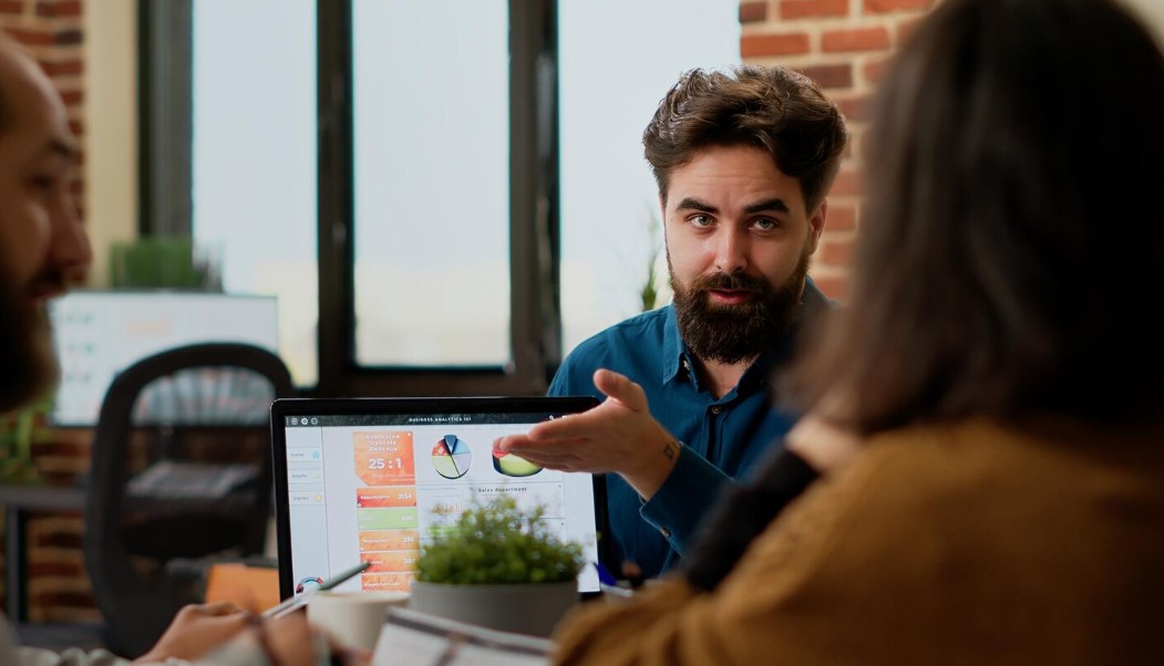 Project manager reviewing business charts with colleagues